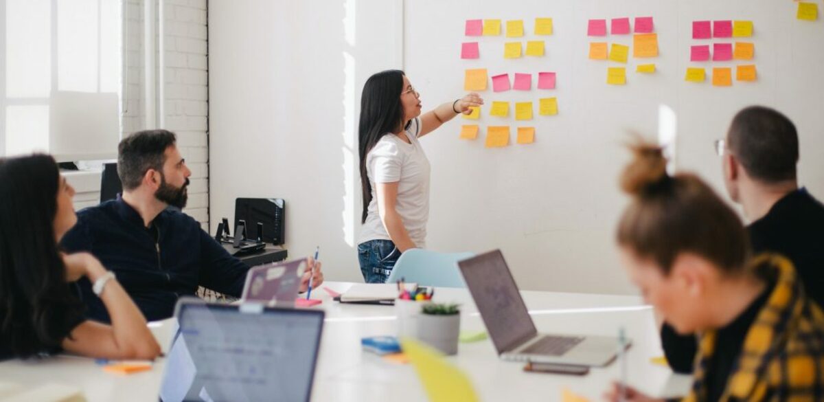 Woman pointing at whiteboard