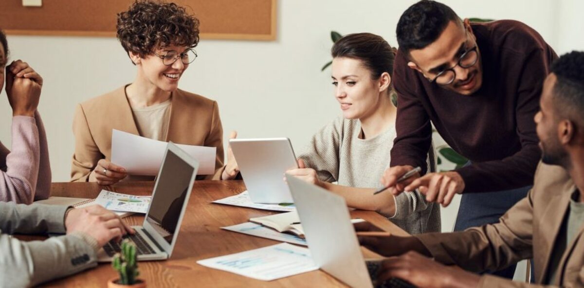 Image of people in office talking 