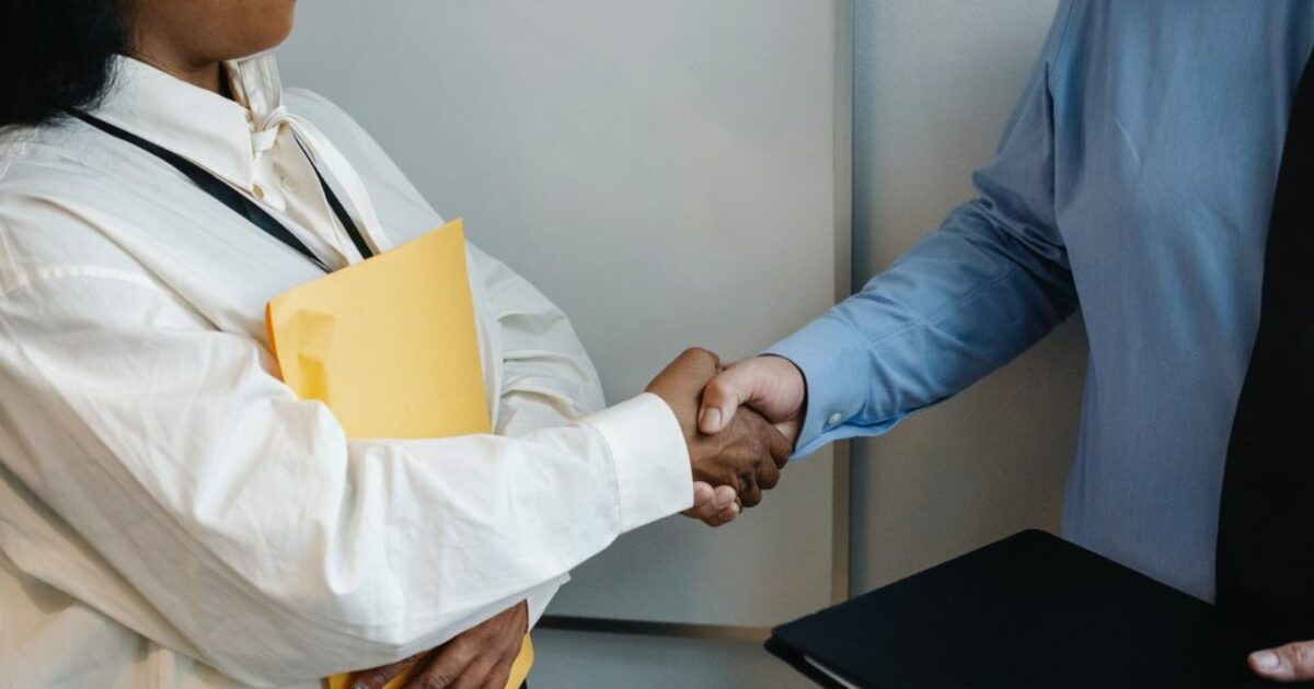 Image of people shaking hands in office