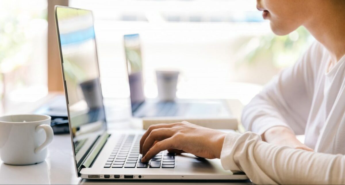 Image of sitting with laptop