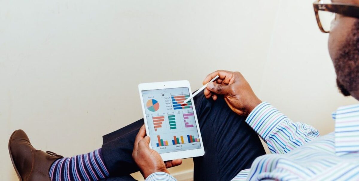 Man with tablet with charts