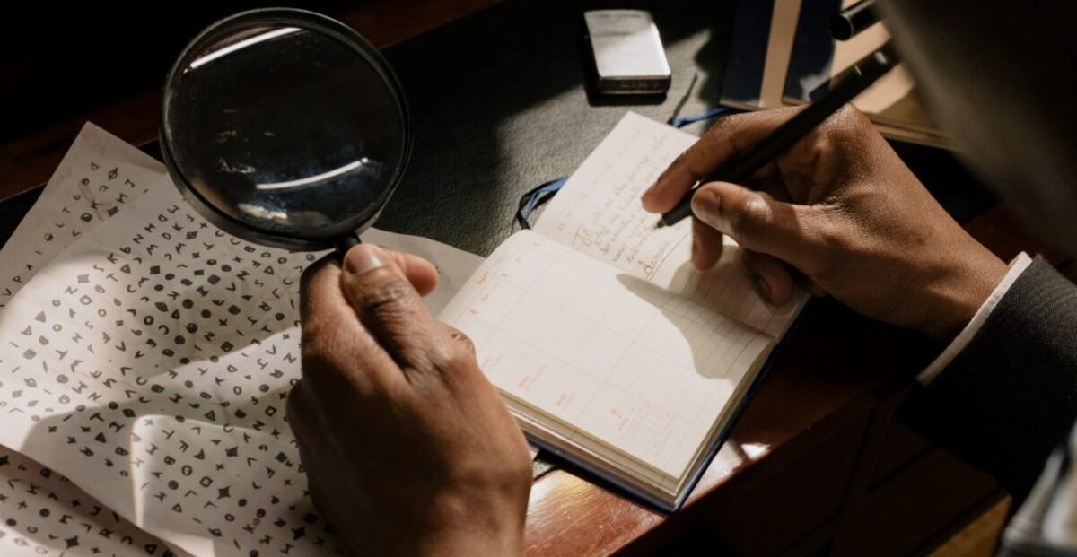 Person writing on white paper