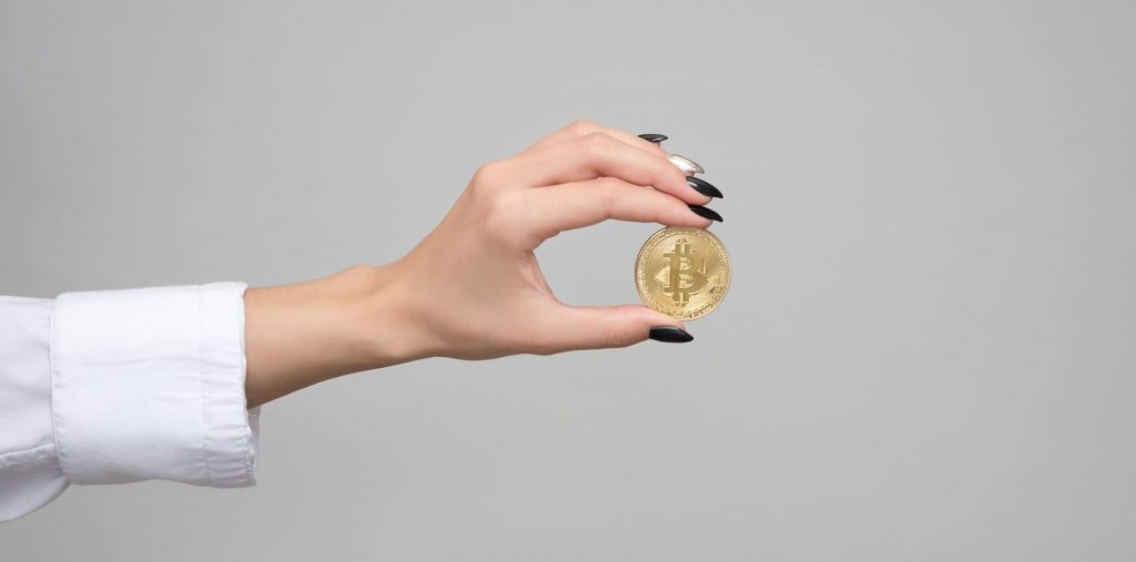 Woman holding a bitcoin