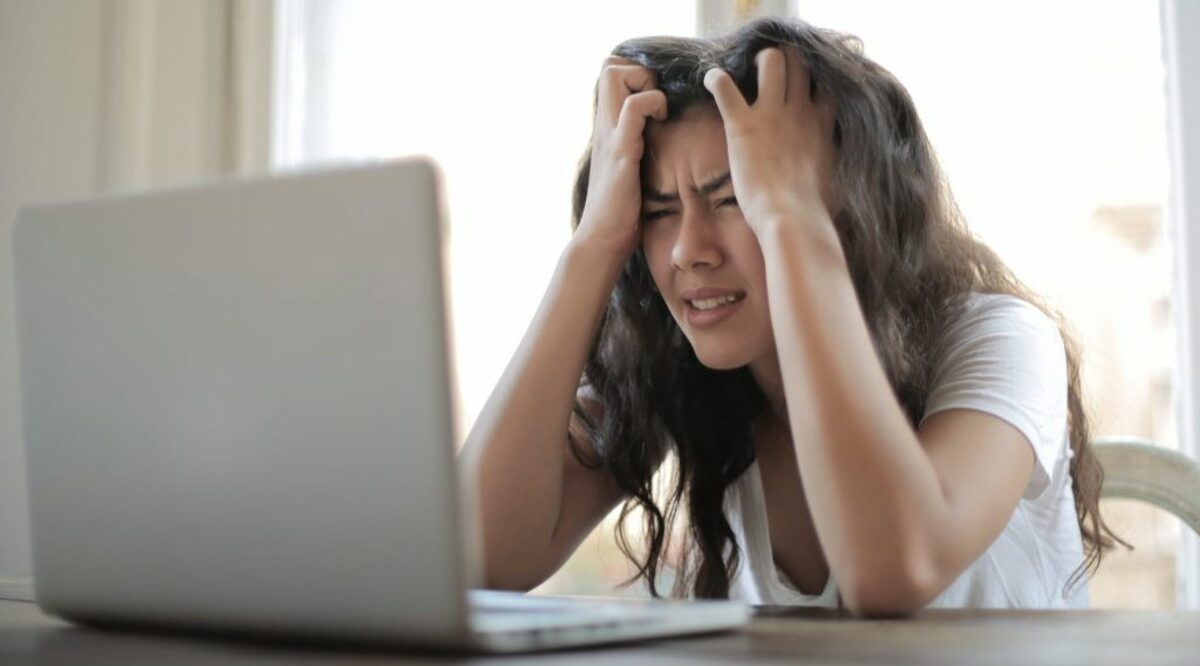 Woman in white shirt showing frustration