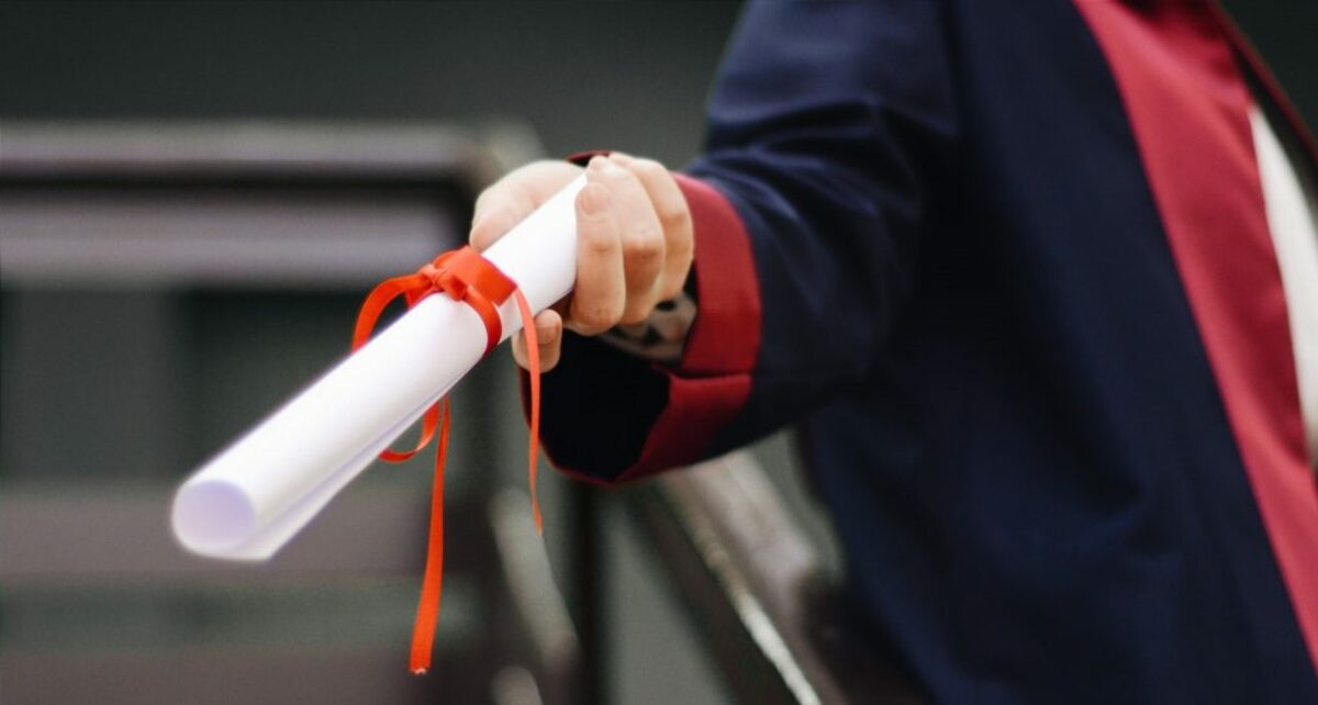 Person holding white scroll