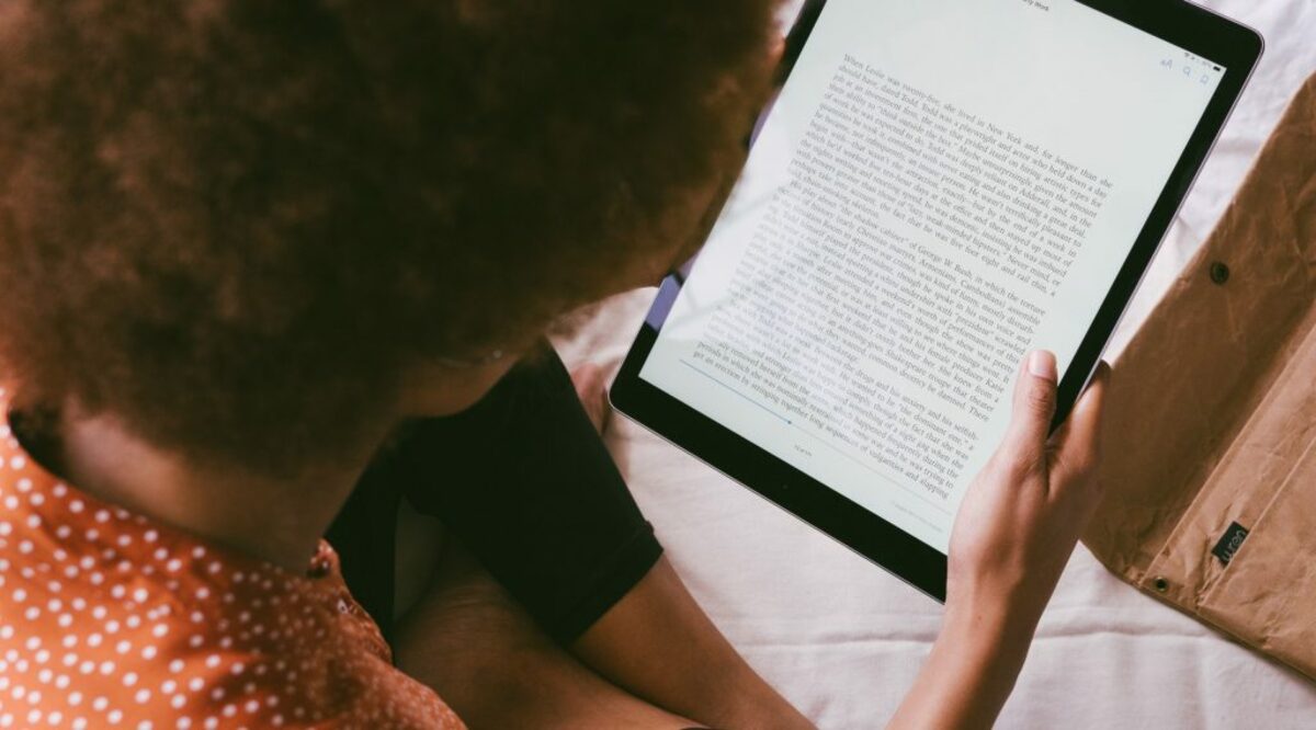 High angle photo of person reading an e book