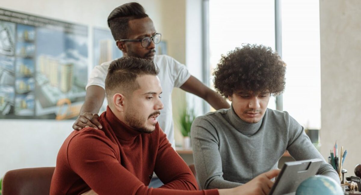 Men doing group discussion on laptop