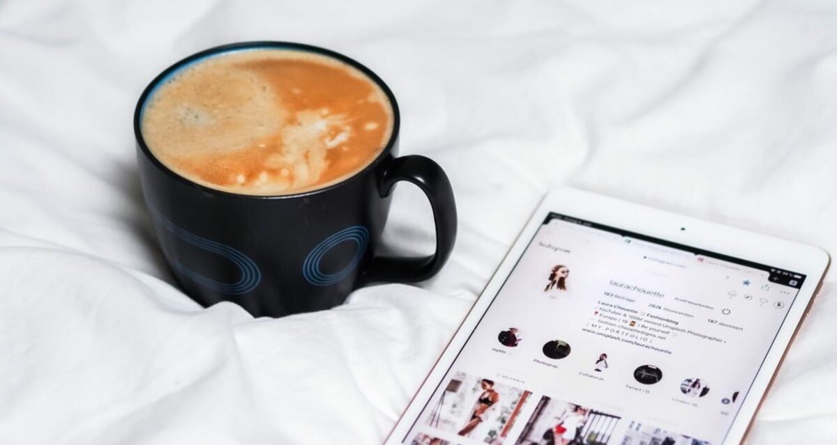 black ceramic mug with brown liquid inside