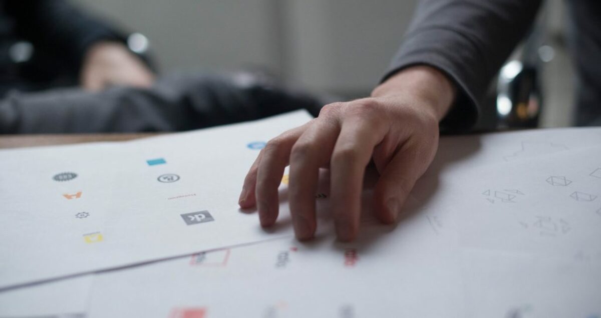 Person holding white printer papers