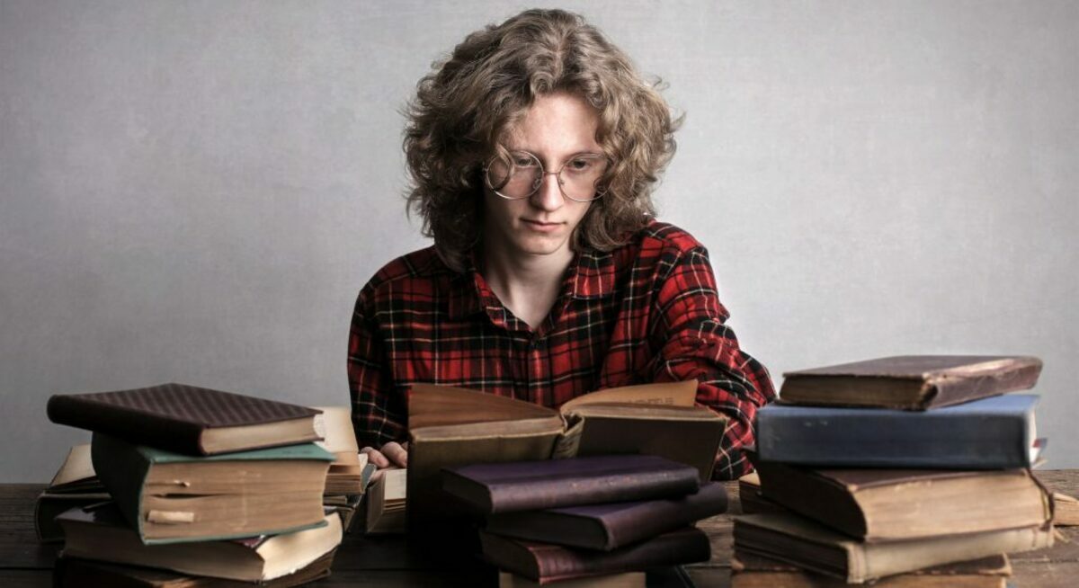 A diligent male student reading a book