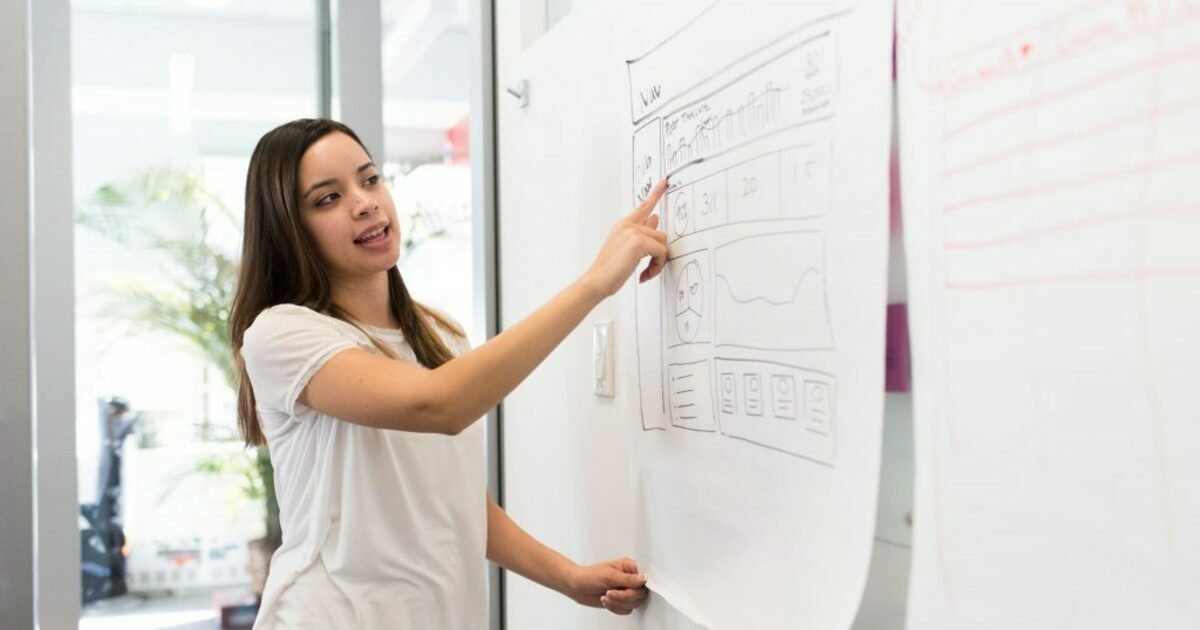 Photo of woman pointing on white paper