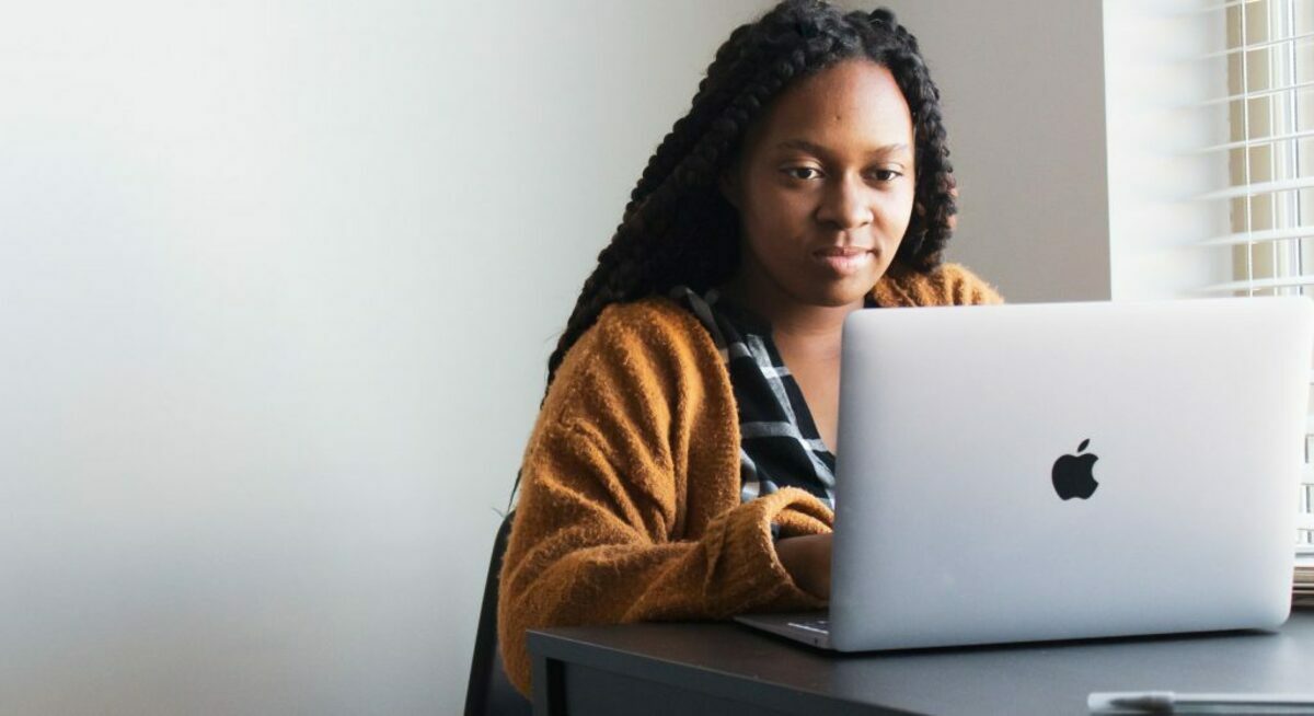 Woman typing on a Macbook