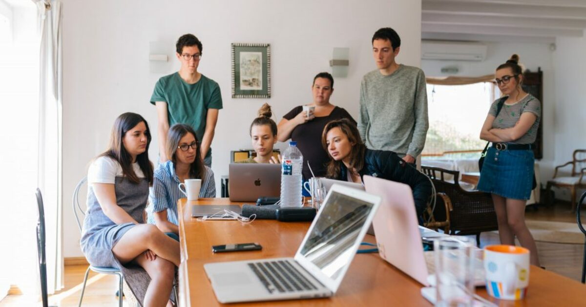 Group of people watching on laptop