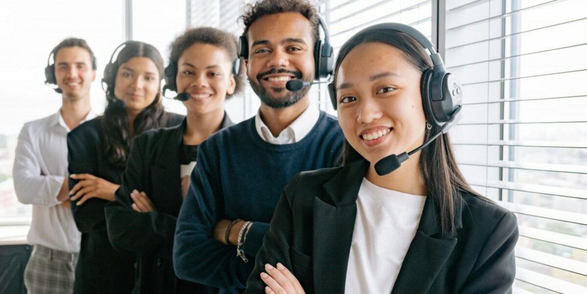 Happy call center agents looking at camera