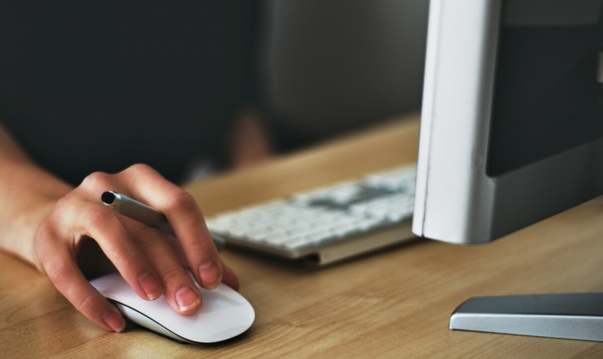 Person holding apple magic mouse