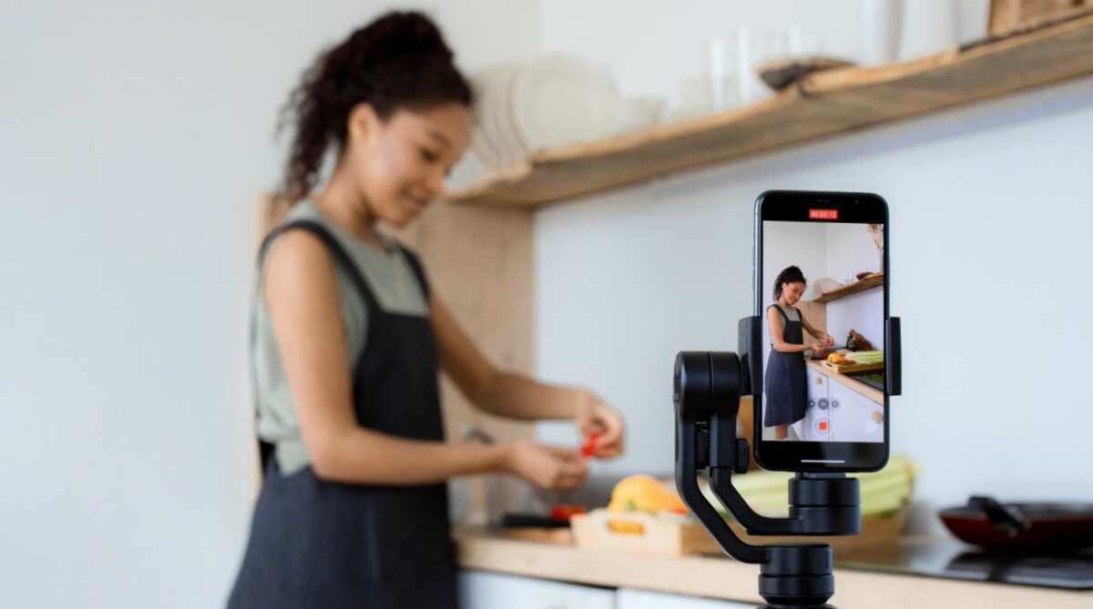 Woman filming herself while preparing food