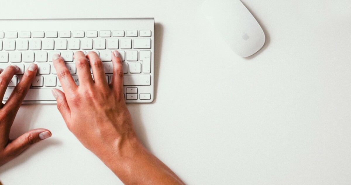 Person holding apple keyboard