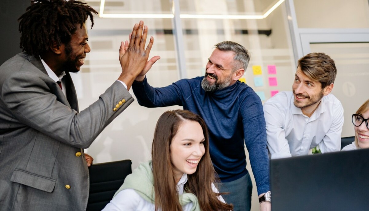 Men doing high five at the office