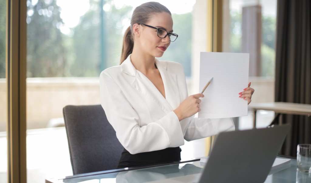 Confident businesswoman sharing information from documents in workplace