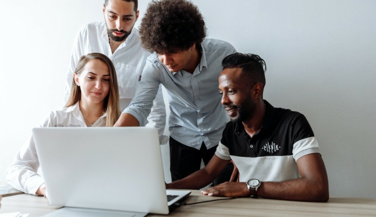 People Pointing at a Laptop