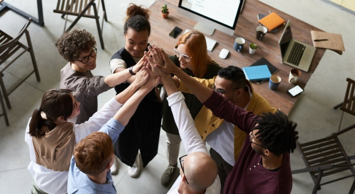 Photo of people holding each other s hands