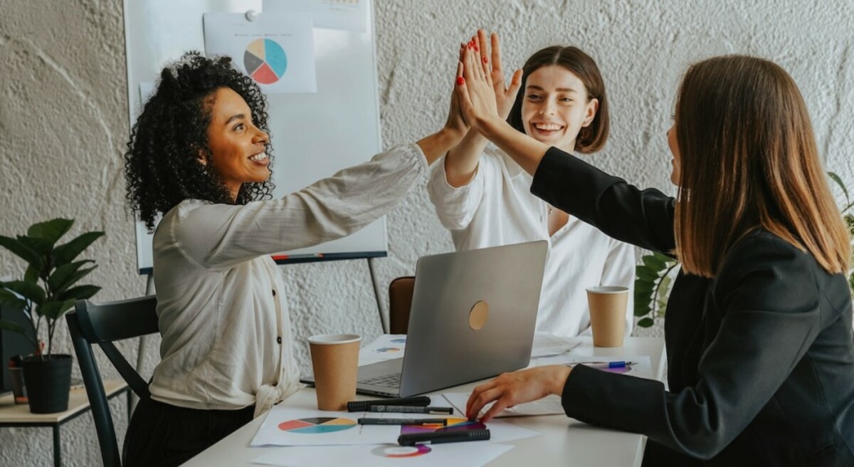 Two women high five