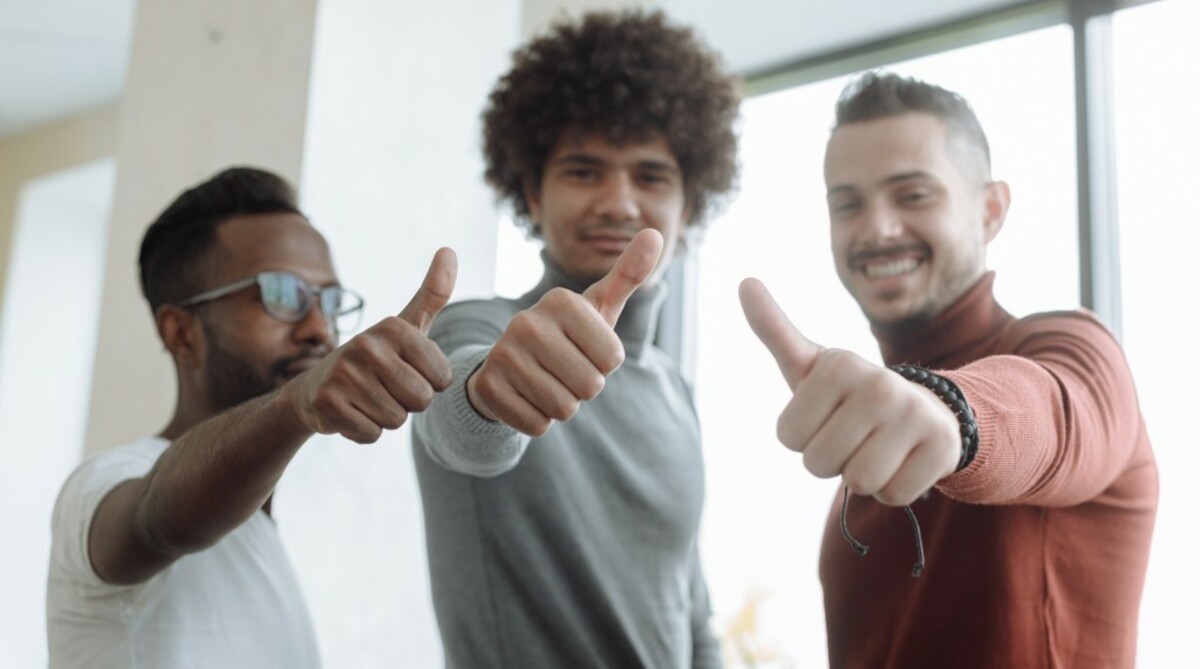 Men putting a thumbs up